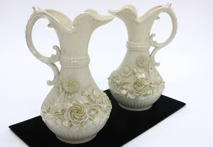 Appraisal: IRISH BELLEEK PAIR ABERDEEN PITCHERS having raised floral decoration on