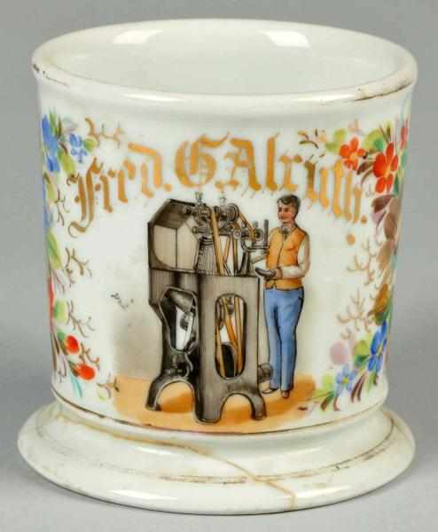 Appraisal: Shoemaker with Machine Shaving Mug Description Gilt name Fred G