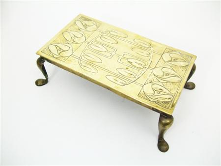 Appraisal: GLASGOW STYLE BRASS TRIVET CIRCA repousse decorated with stylised plant