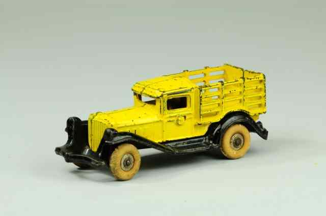 Appraisal: TAKE-APART STAKE TRUCK A C Williams cast iron yellow body