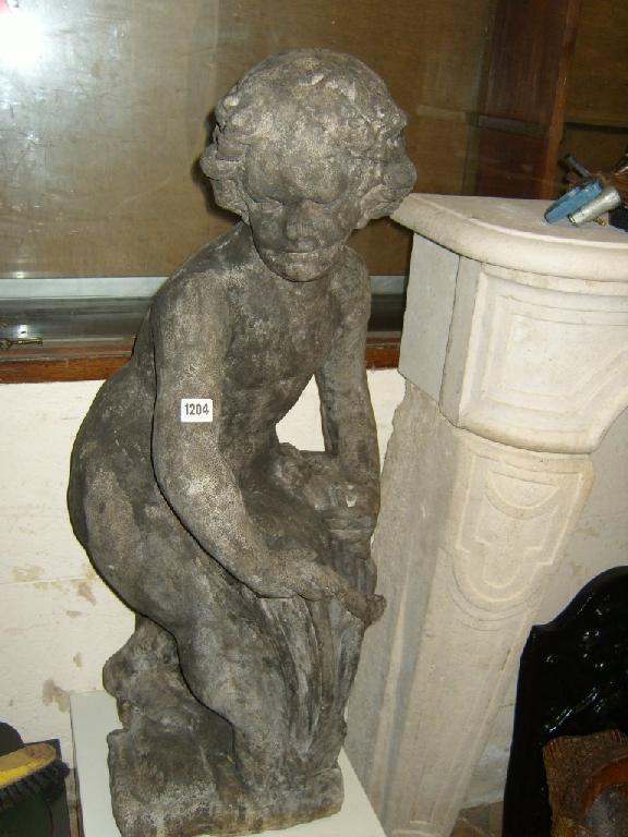 Appraisal: A reconstituted free standing garden figure of a cherub harvesting