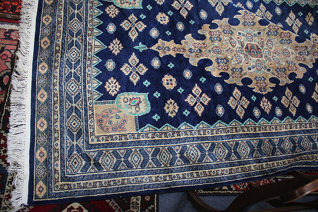 Appraisal: A BLUE GROUND ORIENTAL RUG with geometric decoration to the