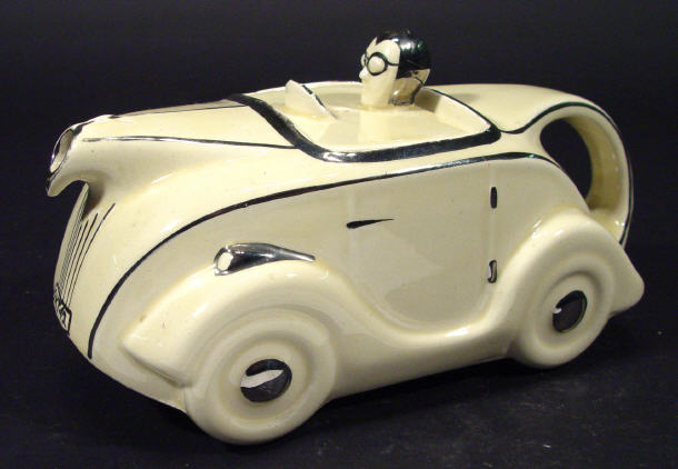 Appraisal: Cream and silver lustre Art Deco racing car teapot impressed