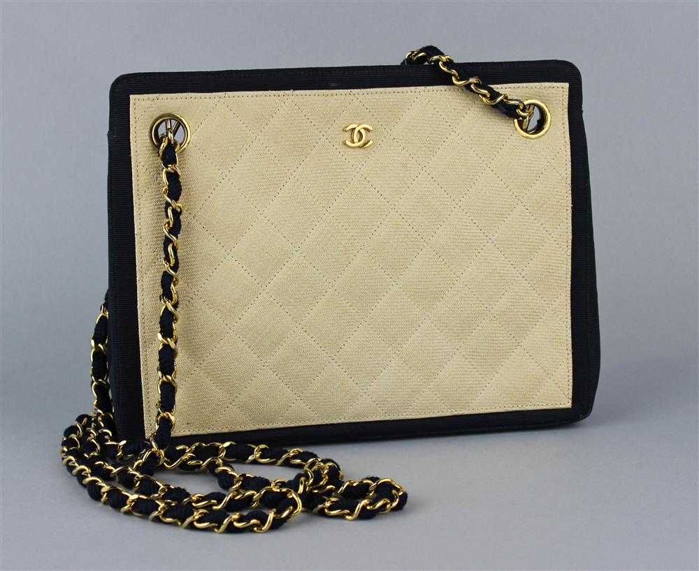 Appraisal: CHANEL IVORY LINEN AND NAVY GROSGRAIN HANDBAG the quilted ivory