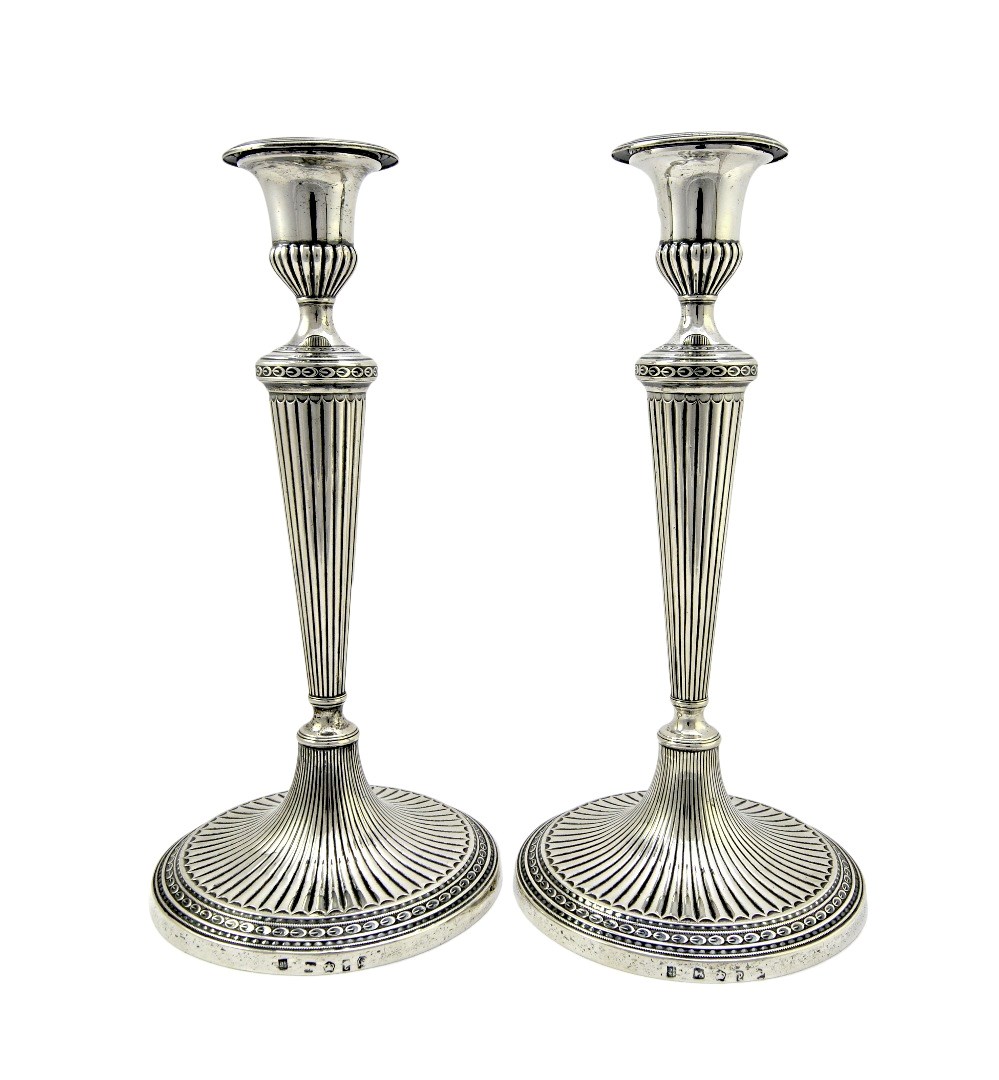 Appraisal: A pair of George III silver table candlesticks each column