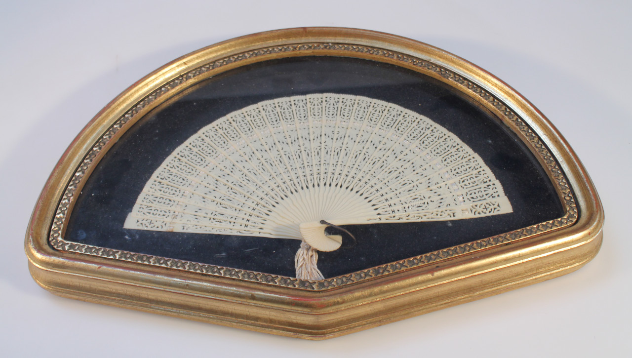 Appraisal: A cased fan of pierced scroll and floral decoration in