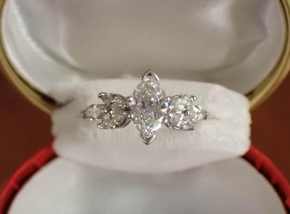 Appraisal: DIAMOND AND FOURTEEN KARAT WHITE GOLD RING with three marquise-cut