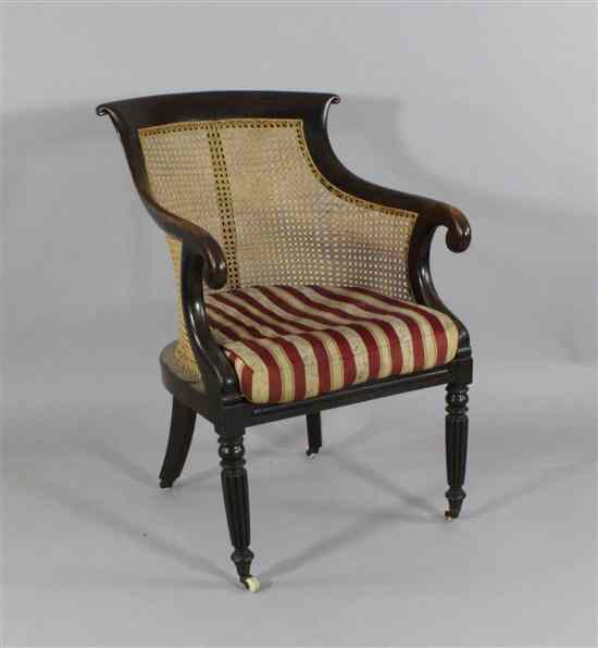 Appraisal: A Regency faux grain rosewood beech bergere chair on turned