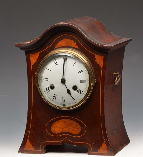 Appraisal: AN EDWARDIAN MAHOGANY MANTEL CLOCK having a convex white enamel