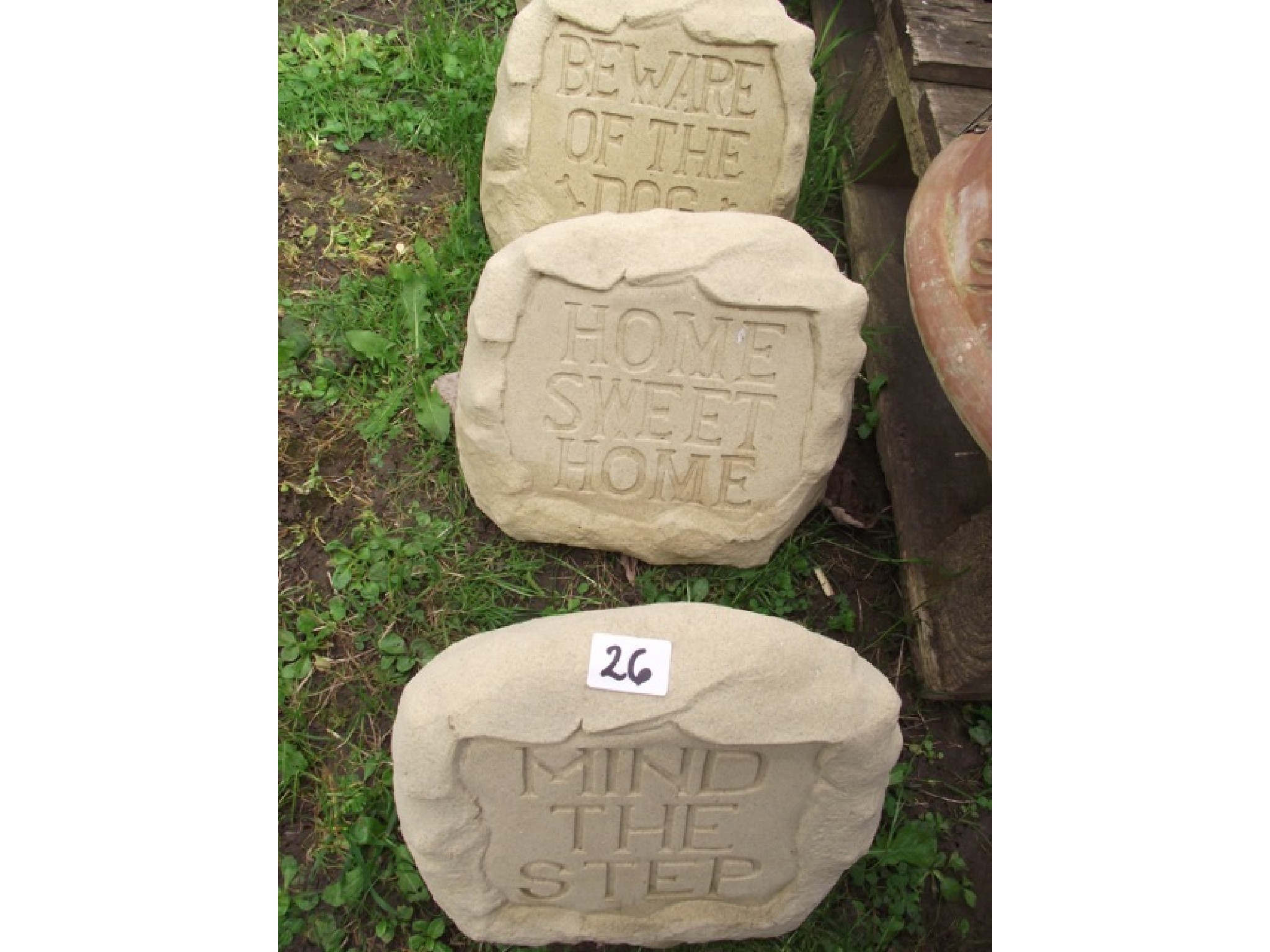 Appraisal: Three contemporary cast composition stone garden notices in the form