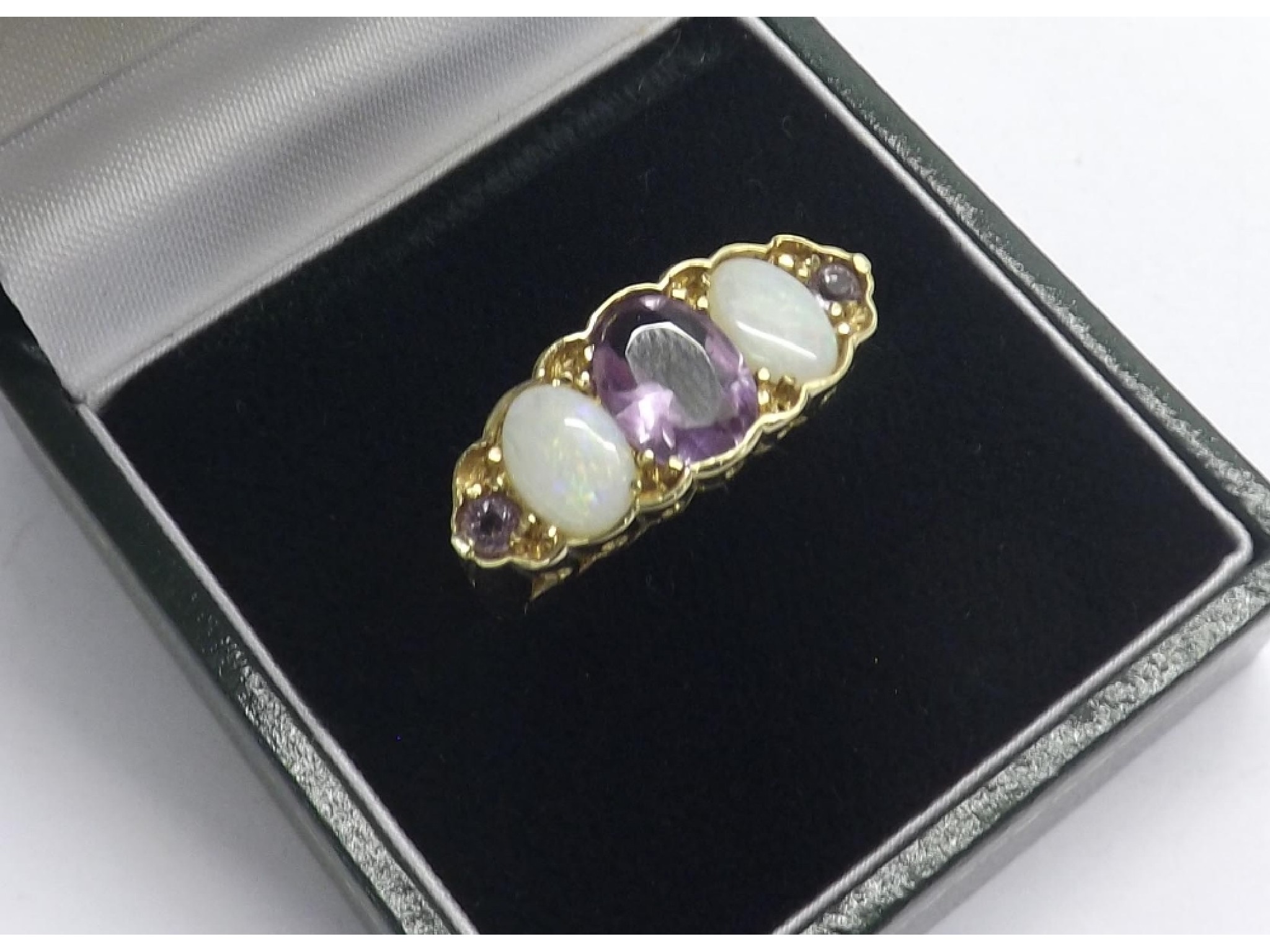 Appraisal: Large amethyst and opal claw set three stone ct yellow