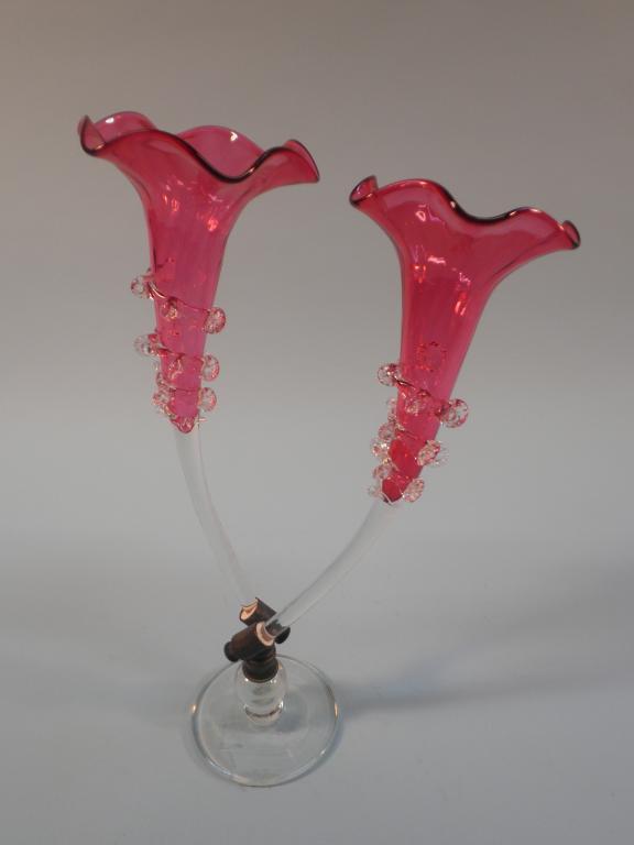 Appraisal: A Victorian epergne with two cranberry tinted trumpet shaped vases