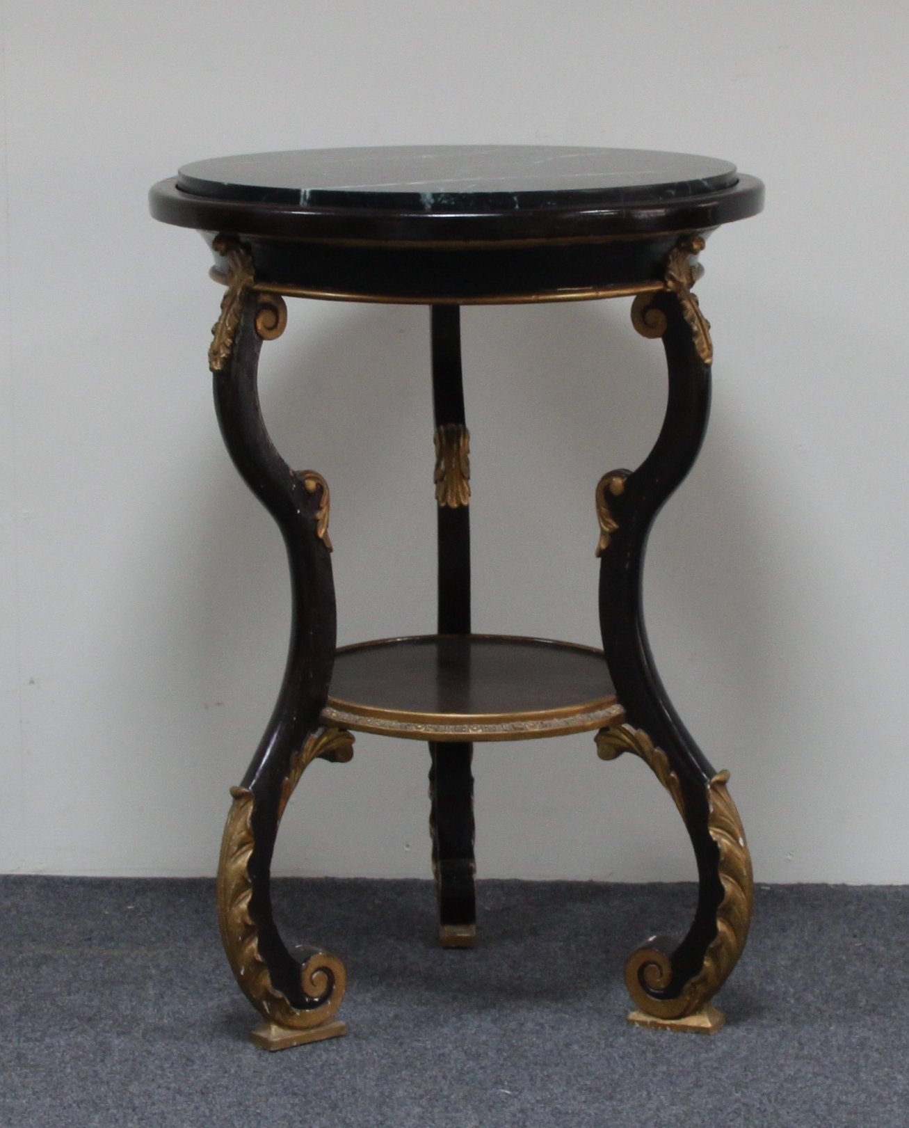 Appraisal: A marbled topped two-tier table the circular marble top on