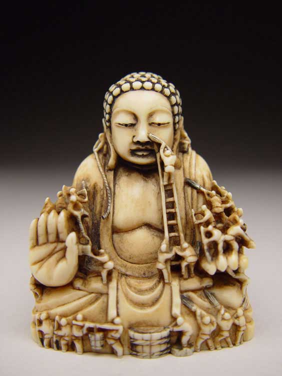 Appraisal: CARVED IVORY NETSUKE Intricately carved contemporary ivory netsuke of a