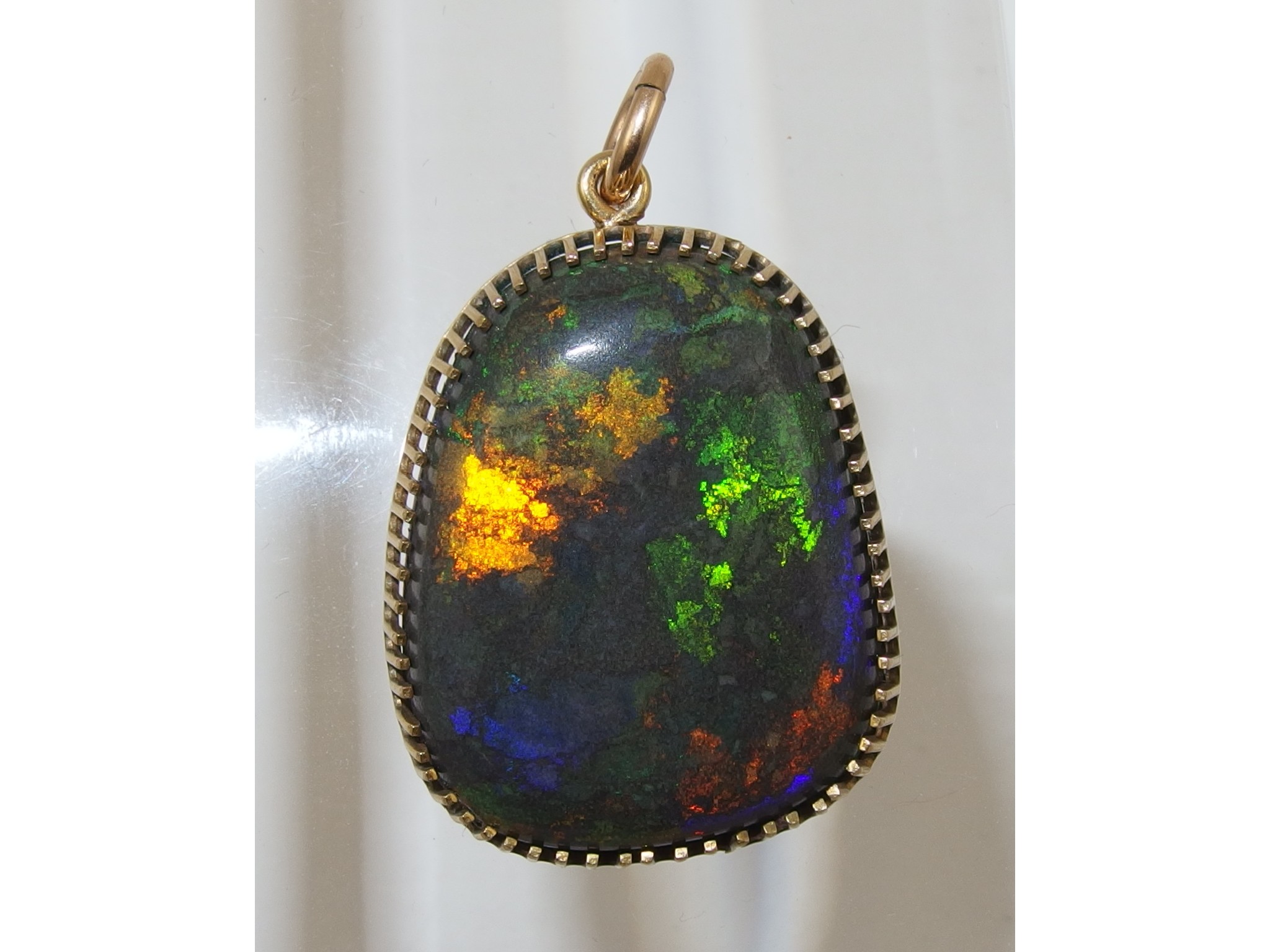 Appraisal: An Andamooka opal matrix pendantin yellow metal galleried mount approx