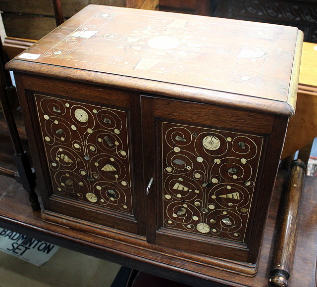 Appraisal: AN ANTIQUE HARDWOOD CABINET with bone and mother of pearl