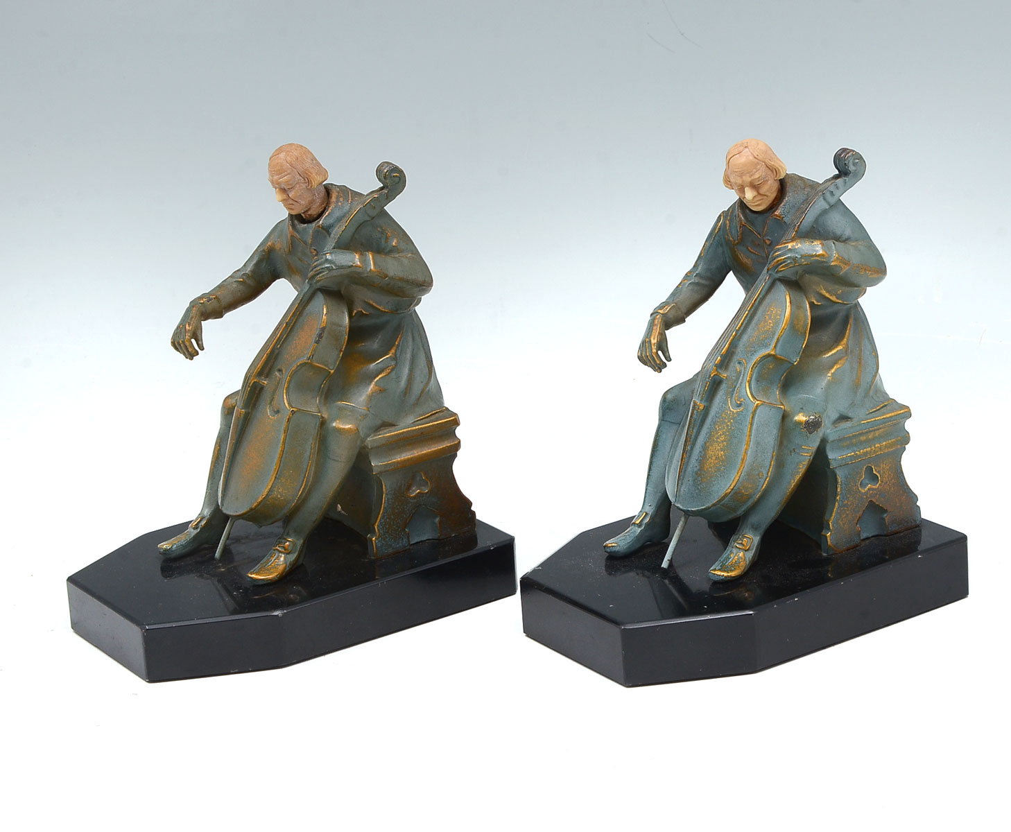 Appraisal: J RUHL CELLO PLAYER BOOKENDS Pair of John Ruhl bookends