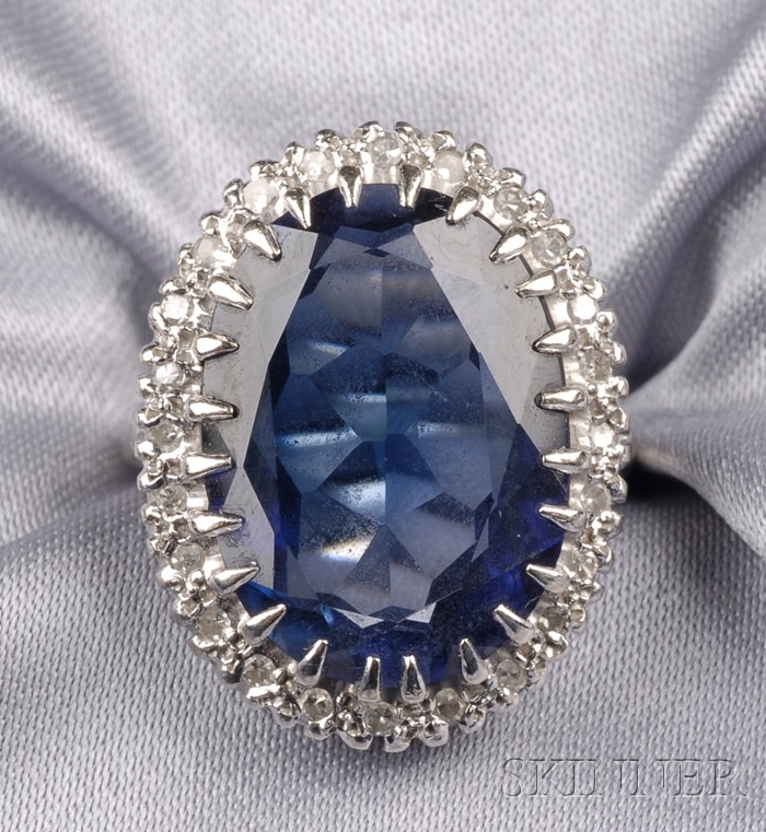 Appraisal: Synthetic Sapphire and Diamond Ring prong-set with an oval cushion-shape