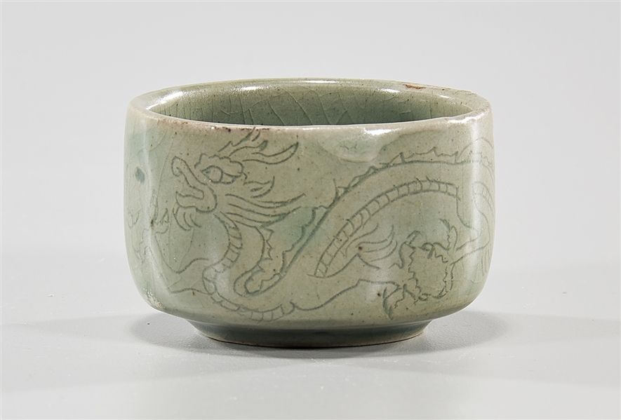 Appraisal: Korean celadon glazed cup with double dragon design x approx