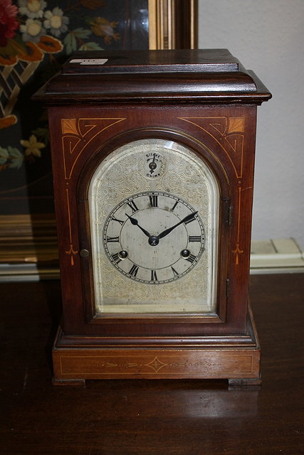 Appraisal: AN EDWARDIAN MAHOGANY AND INLAID MANTEL CLOCK with arched silvered