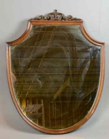 Appraisal: Shield Form Mahogany Wall MirrorShield form mirror with carved and