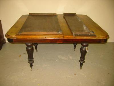 Appraisal: A VICTORIAN MAHOGANY EXTENDING DINING TABLE of rounded oblong form