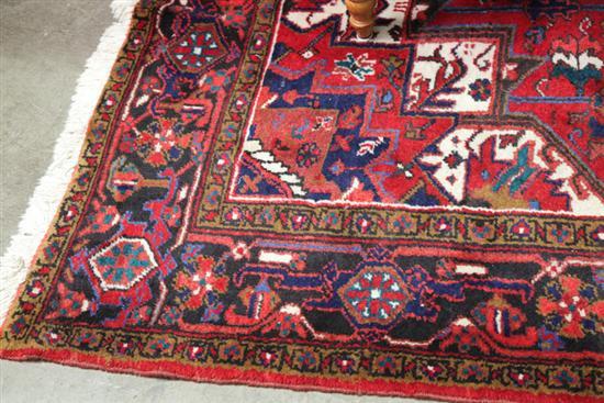 Appraisal: HAND KNOTTED PERSIAN HERIZ Red ground with blues browns and