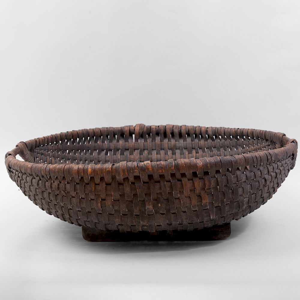 Appraisal: Large Woven Basket On two wood supports x x in