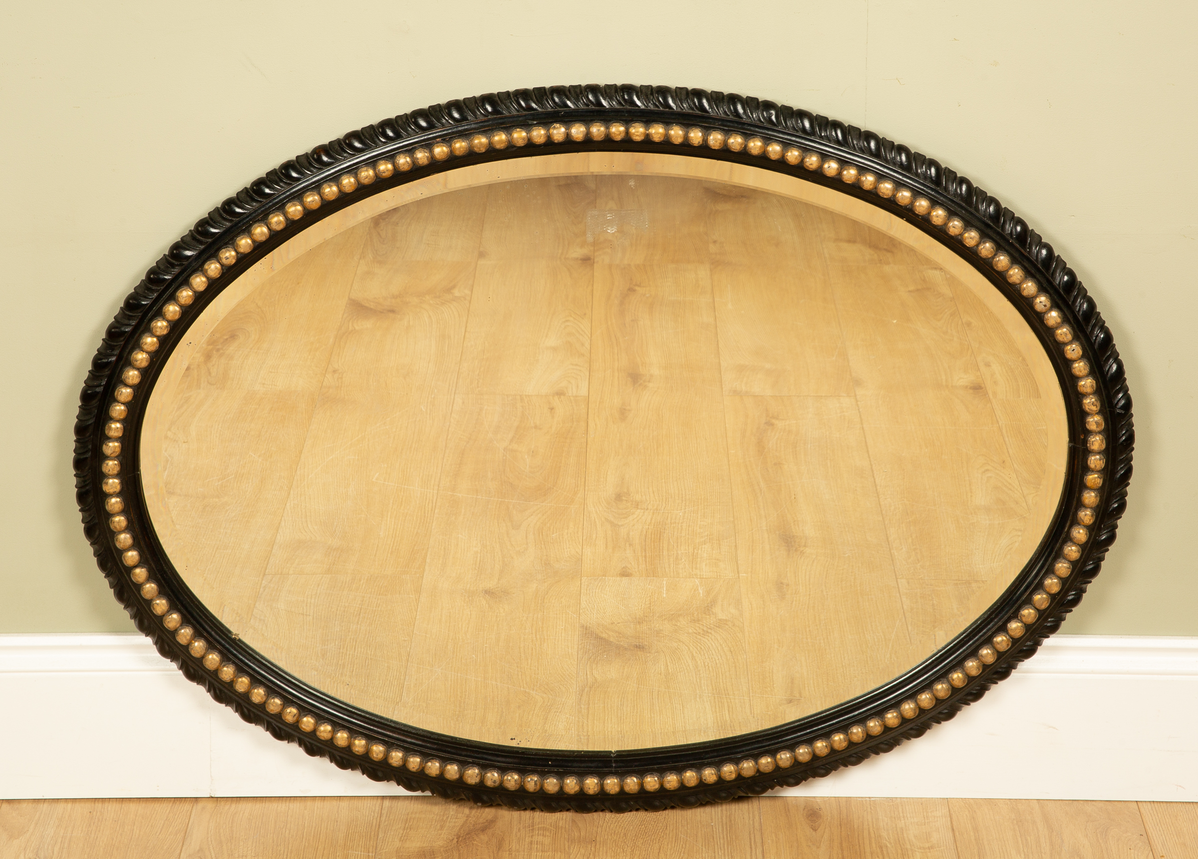 Appraisal: An oval wall mirror the bevelled mirror plate set within