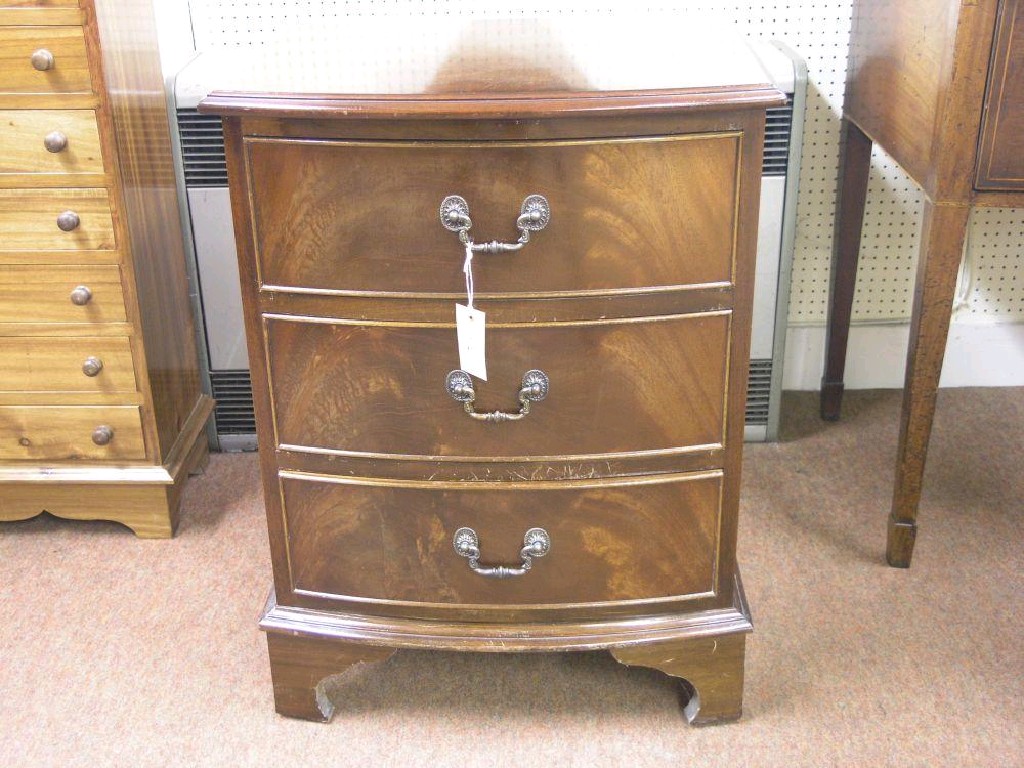 Appraisal: A reproduction bow fronted mahogany chest three drawers each with