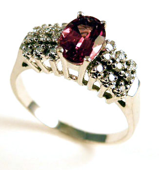 Appraisal: GARNET DIAMOND AND WHITE GOLD RING centering an oval-cut garnet