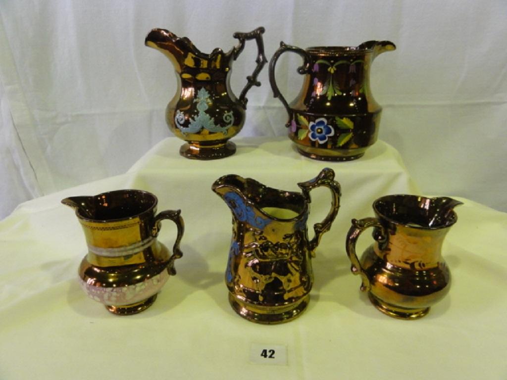 Appraisal: A quantity of th century copper lustre jugs of various