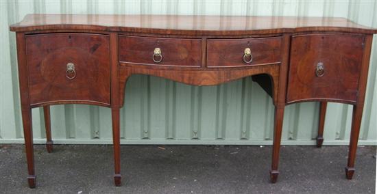 Appraisal: George III mahogany cross banded and ebony strung serpentine sideboard