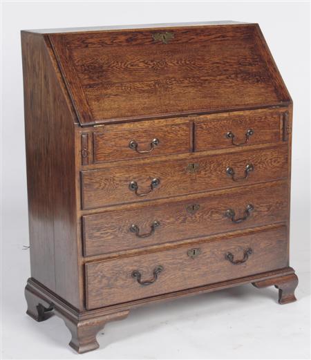 Appraisal: A George III oak bureau the moulded fall-flap enclosing fitted