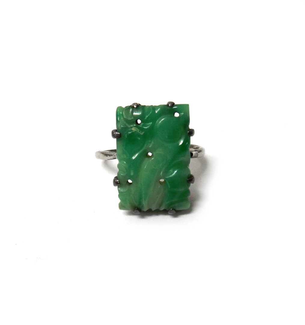 Appraisal: A carved jade ring in a rectangular design carved and