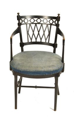 Appraisal: A late Victorian ebonised open armchair in the manner of