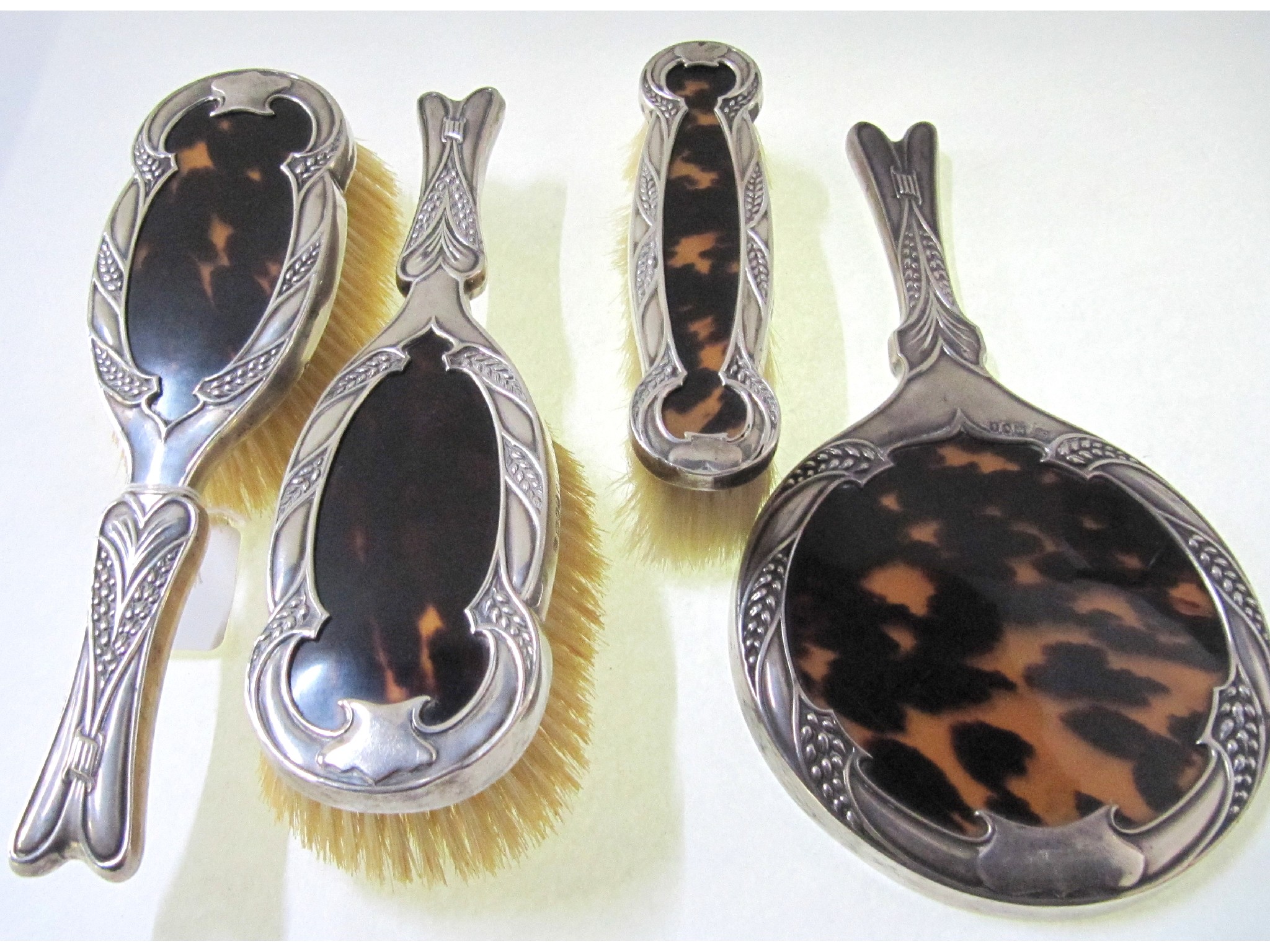 Appraisal: A four piece silver and tortoiseshell dressing table set London