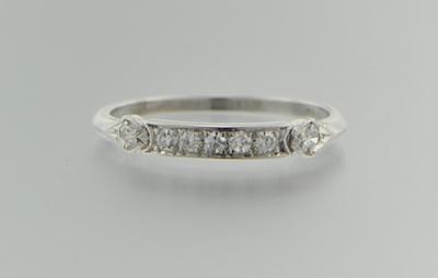 Appraisal: A Platinum and Diamond Band Platinum band set with seven