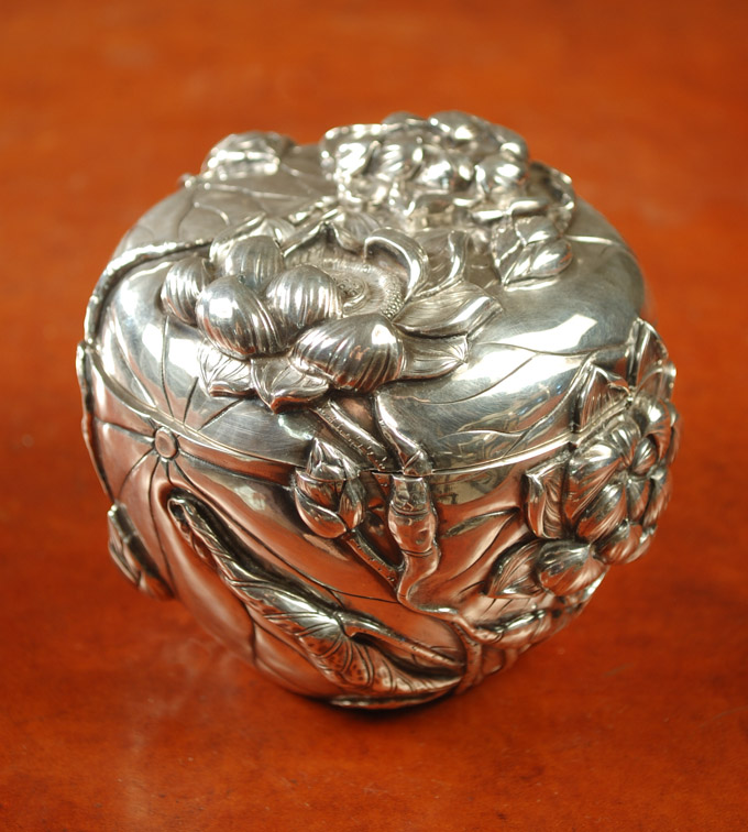 Appraisal: JAPANESE SILVER LIDDED BOX having relief floral design with conforming