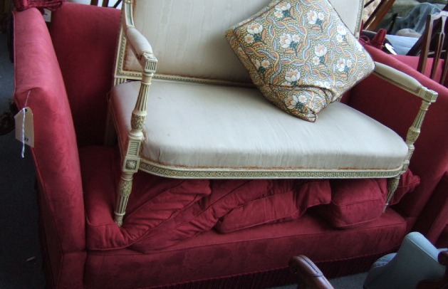 Appraisal: A th century knowle sofa upholstered in patterned red fabric