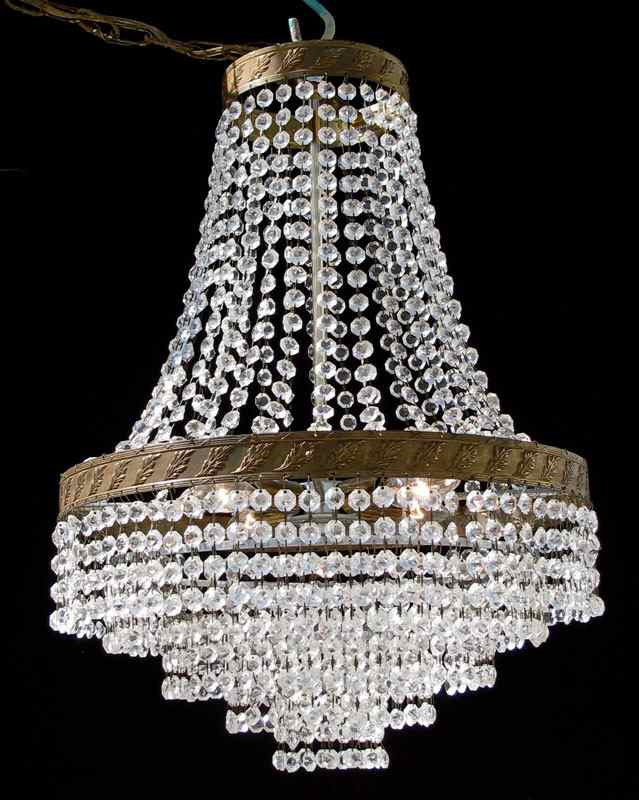 Appraisal: FRENCH EMPIRE STYLE CRYSTAL CHANDELIER Draped crystal chains over tiers