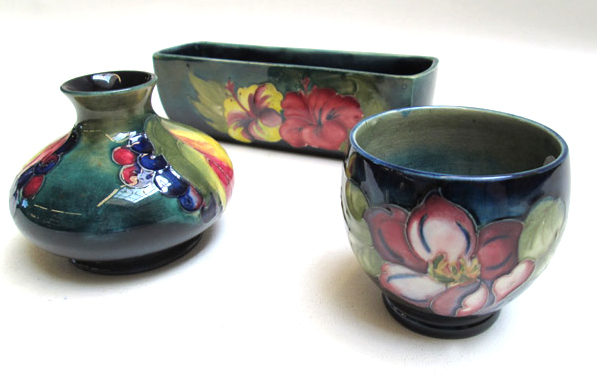 Appraisal: THREE MOORCROFT POTTERY PIECES planter Hibiscus pattern L Leaf and