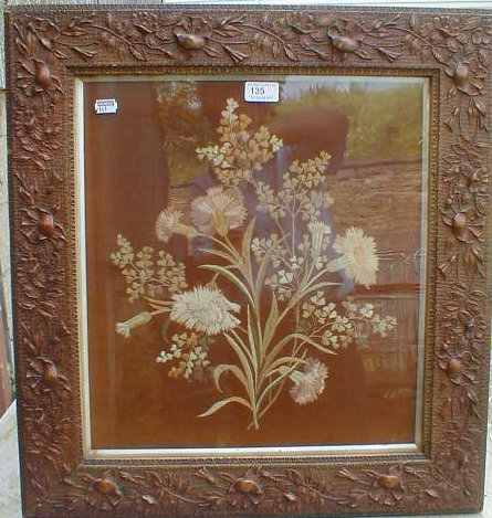 Appraisal: A floral needlework picture enclosed within a moulded high relief