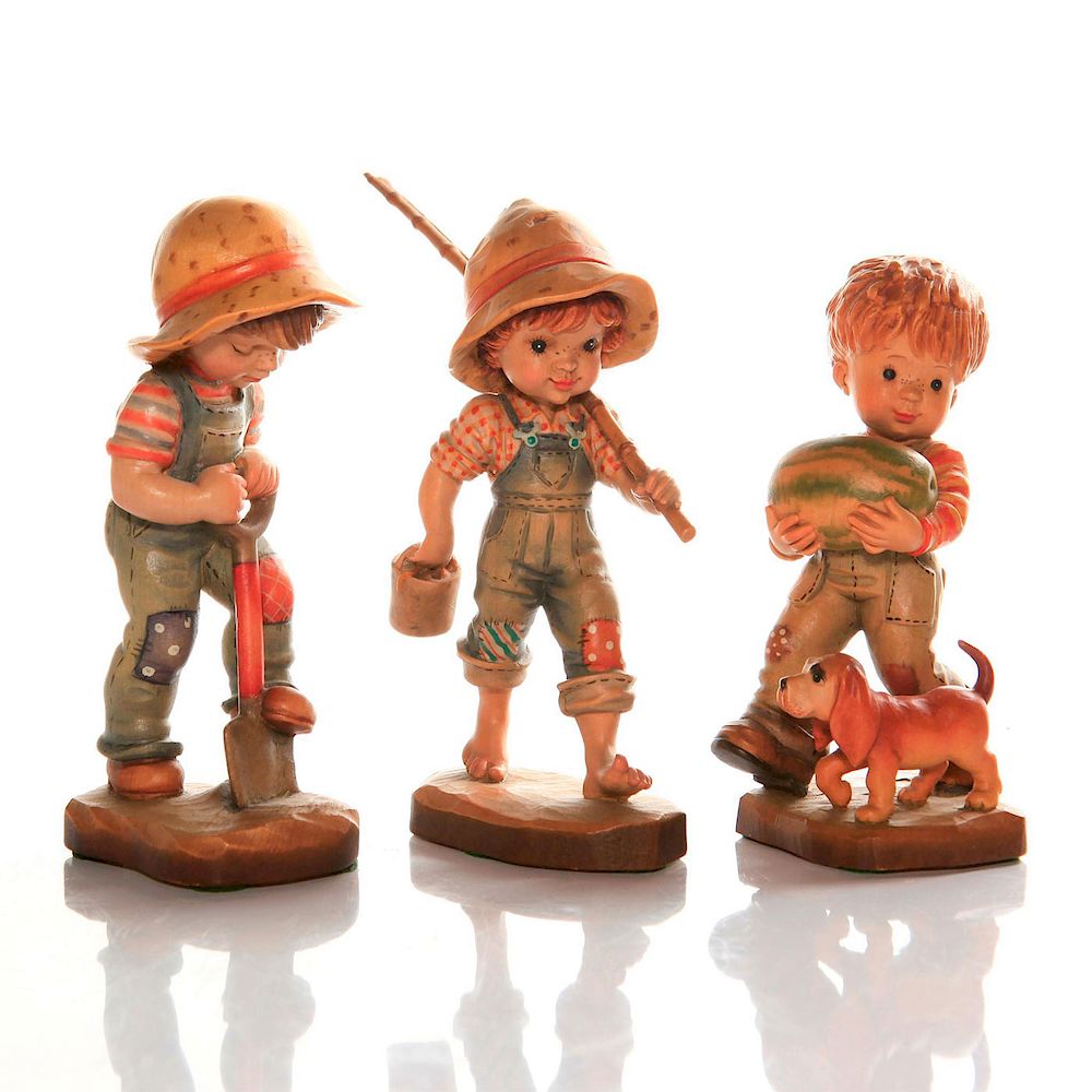 Appraisal: ANRI CARVED WOOD FIGURINES Children with shovel fishing pole watermelon