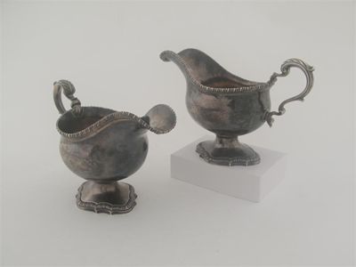 Appraisal: A pair of George III sauceboats on cast and shaped