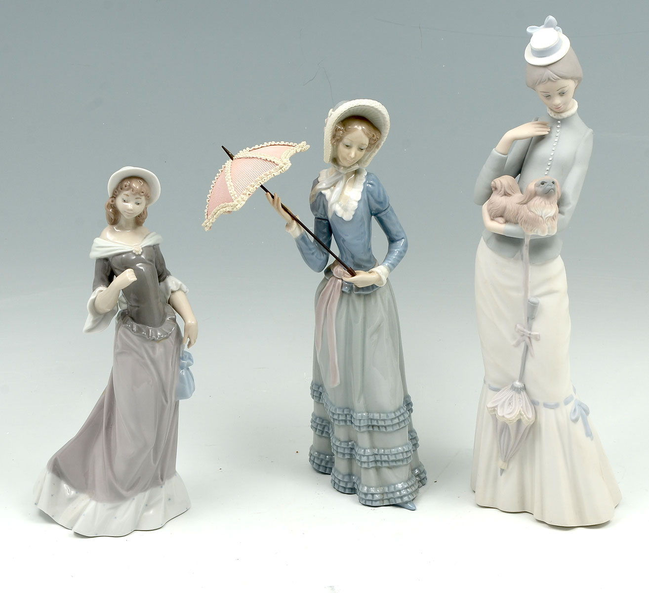 Appraisal: PIECE LLADRO COLLECTION Woman holding small dog and parasol blue