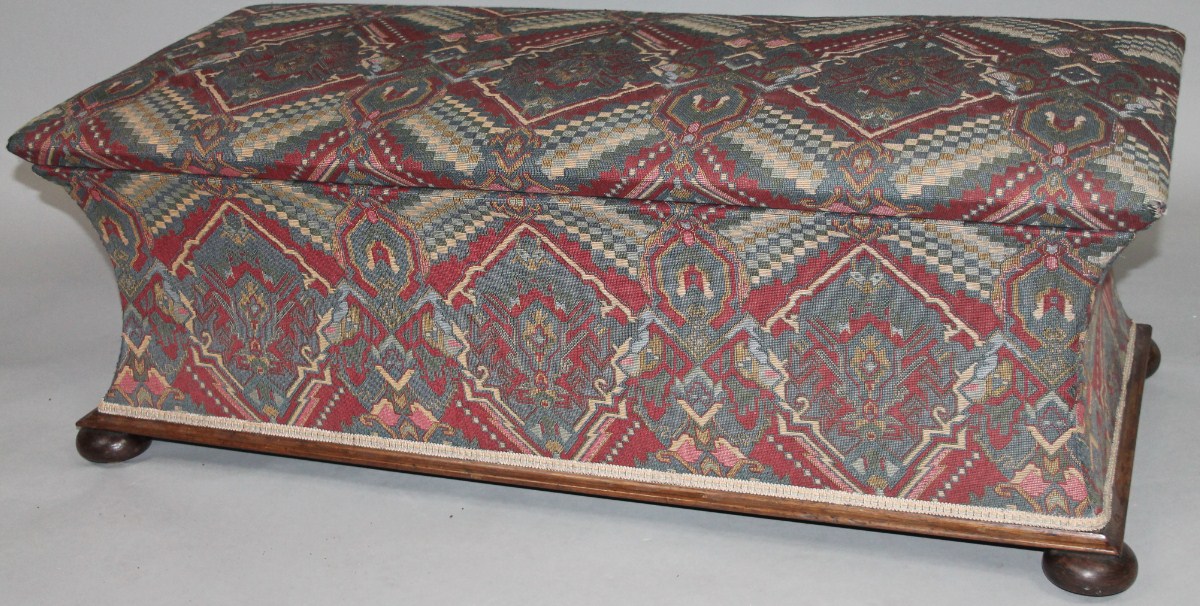 Appraisal: A partially overstuffed Ottoman with a rectangular overhanging lid hinging