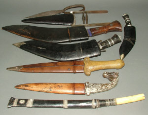 Appraisal: Three various kukris in leather sheaths a khanjar with plated