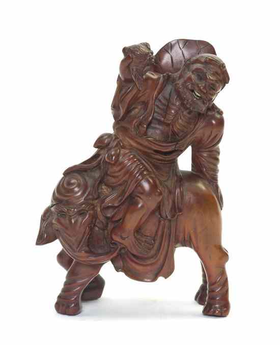 Appraisal: A Chinese Wood Carving of an Emaciated Immortal the figure