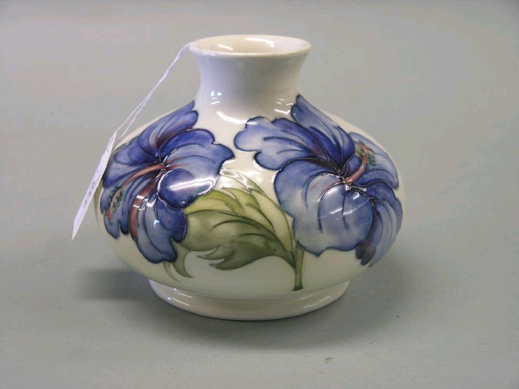 Appraisal: A Moorcroft vase Hibiscus bulbous shape painted against a cream